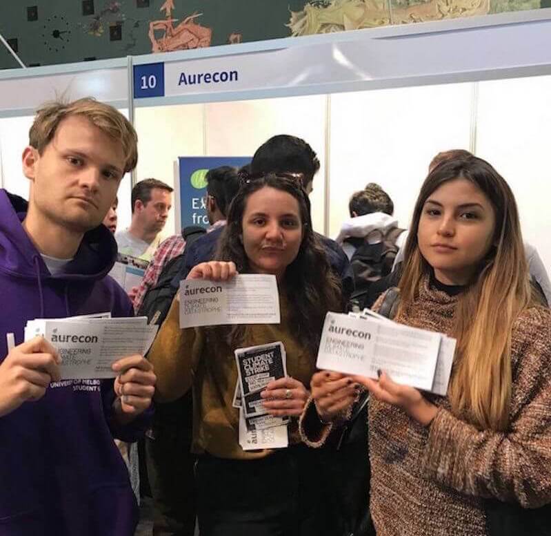 Students give flyers out at Aurecon stand at Melbourne uni careers fair