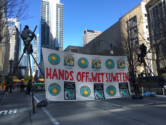 Activists with 350 Seattle and Protectors of the Salish Sea protest the funding of Coastal GasLink and other fossil fuel projects on 19 Feb 2020. Credit: Sulakshana / RAN.