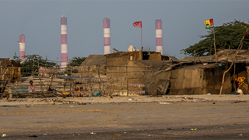 An Adani power plant as seen from the Tragadi fishing community settlement in India. Credit: Stop Adani