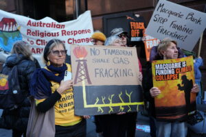 Community members rally outside Macquarie's Sydney CBD office to protest Macquarie's financial support for fracking the Beetaloo Basin ahead of its 2025 AGM.